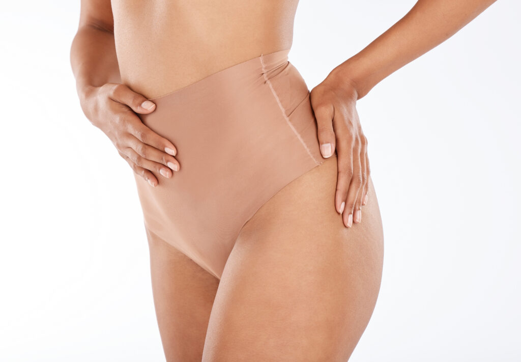 Patient wears compression garment to recover from liposuction in NYC
