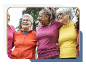 Group of smiling women standing outdoors with arms around each other